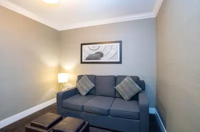 a living room with a blue couch in a room at Sandman Hotel Vancouver Airport in Richmond