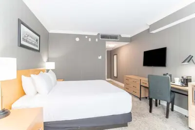 a hotel room with a bed and a desk at Sandman Signature Vancouver Airport Hotel & Resort in Richmond
