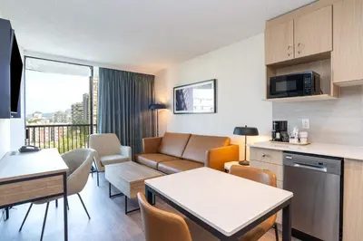 a living room with a couch and a table at Sandman Suites Vancouver on Davie in Vancouver