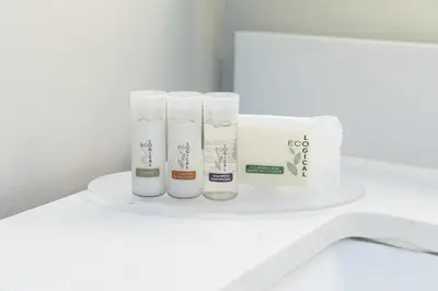 a white shelf with toiletries on a bathroom counter at Days Inn by Wyndham Vancouver Airport in Richmond