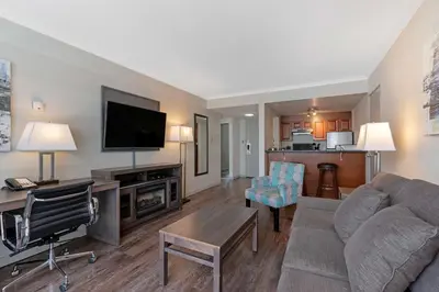 a living room with a couch and a flat screen tv at Best Western Plus Sands in Vancouver