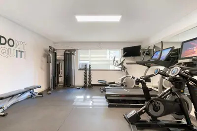a gym with treadmills and elliptical machines at Best Western Plus Sands in Vancouver