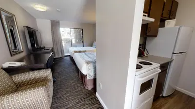 a small room with a kitchen and a living room at Recreation Inn and Suites Kelowna in Kelowna