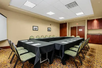 a conference room with a long table and chairs at Holiday Inn & Suites Lloydminster by IHG in Lloydminster