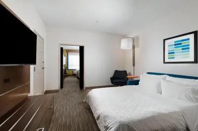 a hotel room with a bed and a flat screen tv at Holiday Inn Express Grande Prairie by IHG in Grande Prairie