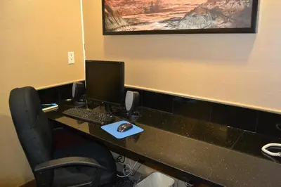 an office cubicle with a desk with a computer on it at Holiday Inn Express Red Deer by IHG in Red Deer