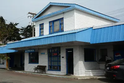 a blue and white building with a blue roof at Bluebird Motel in Port Alberni