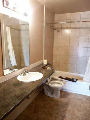 a bathroom with a sink and a toilet at Alaskan Motel in Fox Creek