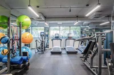 a gym with treadmills and exercise bikes in it at La Grande Residence at the Sutton Place Hotel in Vancouver