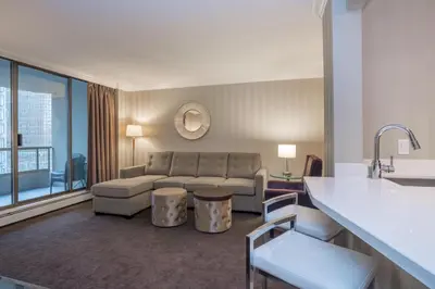 a living room with a couch and a table at La Grande Residence at the Sutton Place Hotel in Vancouver