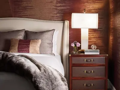 a bedroom with a bed and a nightstand with a lamp at Fairmont Hotel Macdonald in Edmonton