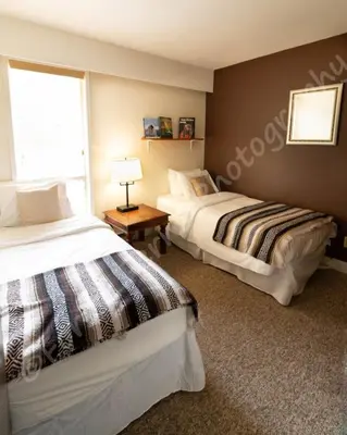 two beds sitting next to each other in a bedroom at The Surf Lodge and Pub in Gabriola