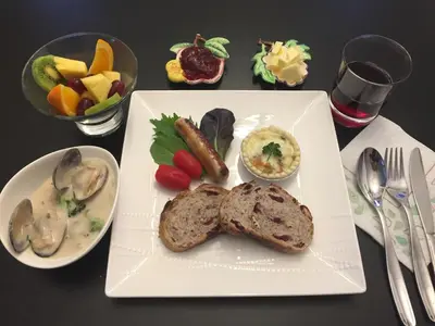 a plate of food with bread and vegetables on a table at Bed & Breakfast Monarch in Canmore