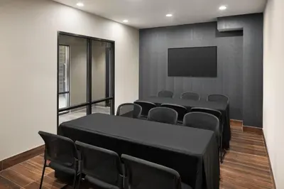 a conference room with a table and chairs and a flat screen tv at Fairfield Inn & Suites by Marriott West Kelowna in West Kelowna