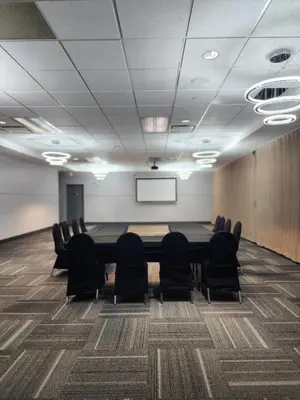 a conference room with a long table and chairs at Merit Hotel & Suites in Fort McMurray
