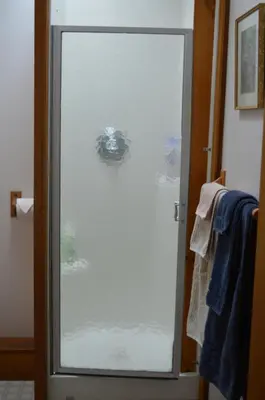 a glass door to a shower in a bathroom at Estuary House Reflexology B&B in Courtenay