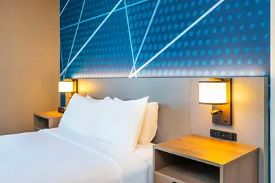 a hotel room with a bed and a table at Comfort Suites Kelowna in Kelowna