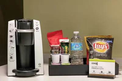 a coffeemaker and a box with some food and drinks at Home2 Suites by Hilton Fort St. John in Fort Saint John