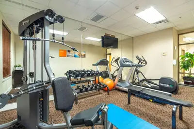 a gym with several tread machines in a room at Comfort Inn & Suites in Surrey