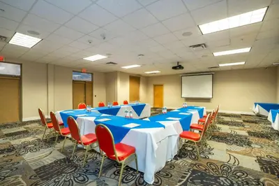 a conference room with blue tables and red chairs at Comfort Inn & Suites in Surrey