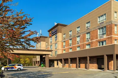 a building with a car parked in front of it at Comfort Inn & Suites in Surrey