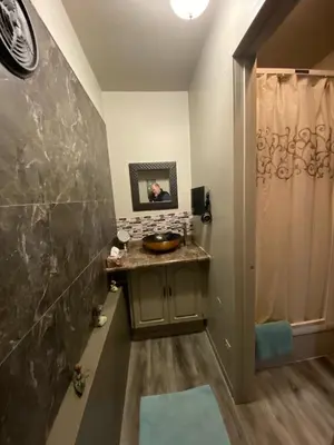 a bathroom with a sink and a shower at Guesthouse Austria in Stewart