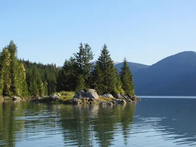 a small island in the middle of a body of water at Guesthouse Austria in Stewart