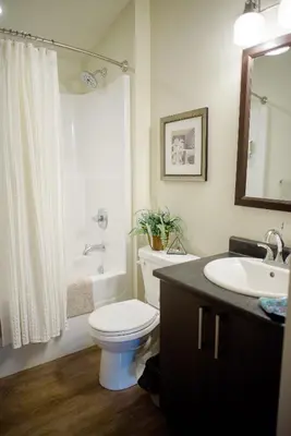 a bathroom with a white toilet and a sink at Fish Tales Cottage in Port Renfrew