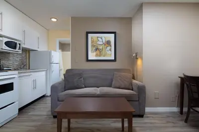 a living room with a couch and a table at Siesta Suites in Kelowna