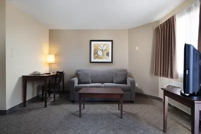 a living room with a couch and a table at Siesta Suites in Kelowna