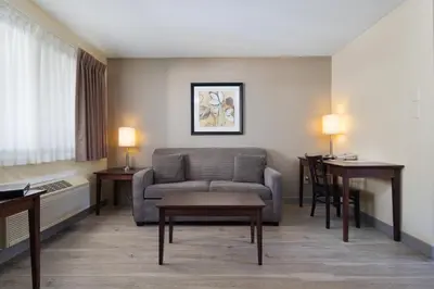 a living room with a couch and a table at Siesta Suites in Kelowna