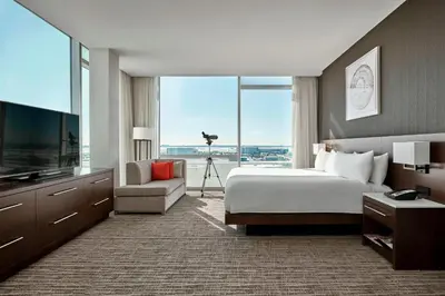 a hotel room with a bed and a large window at Calgary Airport Marriott In-Terminal Hotel in Calgary