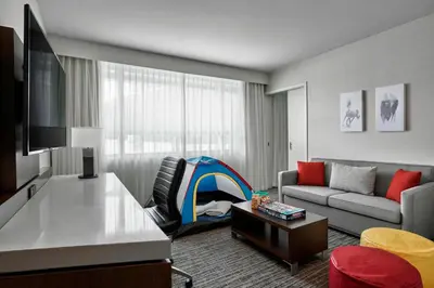 a living room with a couch and a table at Calgary Airport Marriott In-Terminal Hotel in Calgary