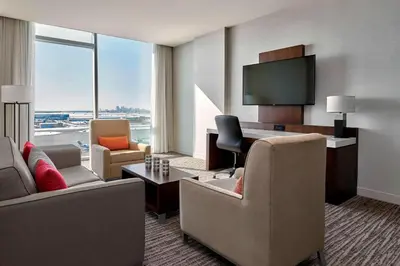 a hotel room with a living room with a view of an airport at Calgary Airport Marriott In-Terminal Hotel in Calgary