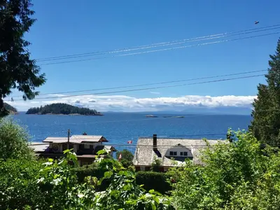 a view of a large body of water with a house at Garden Bridge House in Sechelt