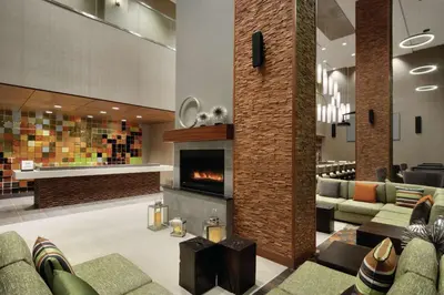 a lobby with couches and a fireplace at Hilton Garden Inn Calgary Downtown in Calgary