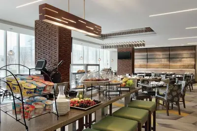 a cafeteria with a buffet of food on a table at Homewood Suites by Hilton Calgary Downtown in Calgary