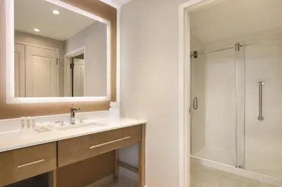 a bathroom with a sink and a shower at Homewood Suites by Hilton Calgary Downtown in Calgary