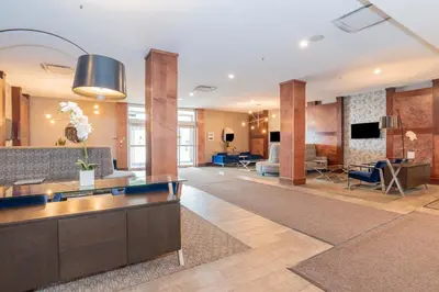a living room with a couch and a table at Sandman Hotel Edmonton West in Edmonton