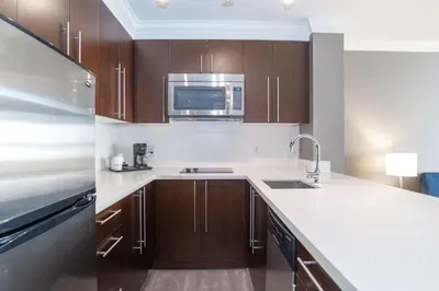 a kitchen with a sink and a microwave at Sandman Hotel Edmonton West in Edmonton
