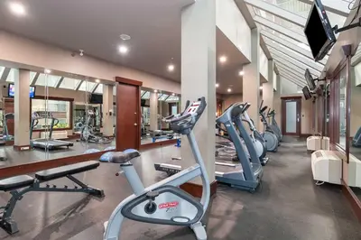 a gym with several treadmills and exercise bikes at Sandman Hotel Edmonton West in Edmonton