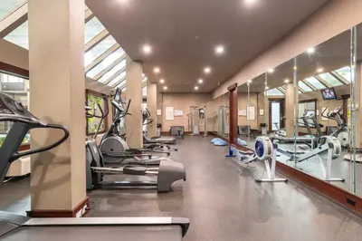 a gym with several treadmills and cardio machines at Sandman Hotel Edmonton West in Edmonton