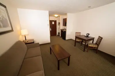 a living room with a couch and a table at Holiday Inn Express & Suites Whitecourt by IHG in Whitecourt