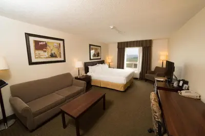 a hotel room with a bed and a couch at Holiday Inn Express & Suites Whitecourt by IHG in Whitecourt