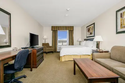 a hotel room with a bed and a desk at Holiday Inn Express & Suites Whitecourt by IHG in Whitecourt