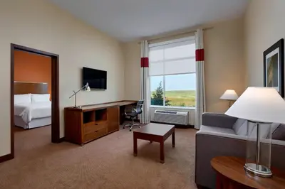 a hotel room with a bed and a desk at Four Points by Sheraton Sherwood Park in Sherwood Park