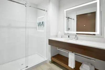 a bathroom with a sink and a shower at Four Points by Sheraton Sherwood Park in Sherwood Park