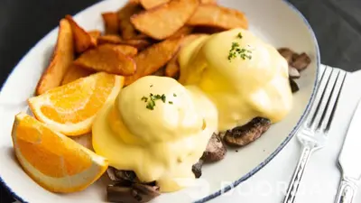 a white plate of food with eggs and french fries at Four Points by Sheraton Sherwood Park in Sherwood Park
