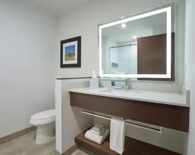 a bathroom with a sink and a toilet at Four Points by Sheraton Sherwood Park in Sherwood Park