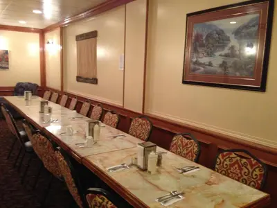a conference room with a long table and chairs at Sundre Motor Inn in Sundre